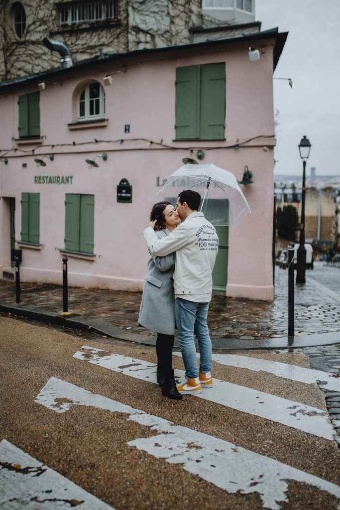 Couple in paris montmartre during rainy elopement photoshoot