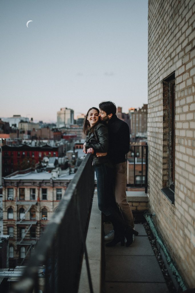 Engagement shoot on nyc fire escape at blue hour with moon