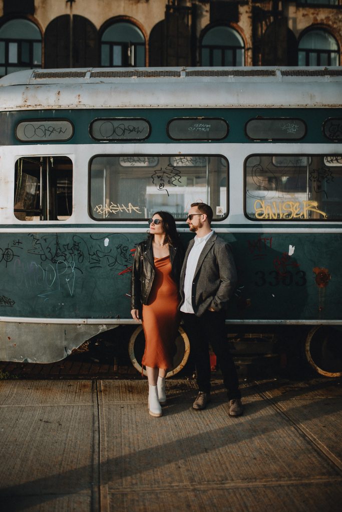 Couple taking engagement photos in brooklyn red hook