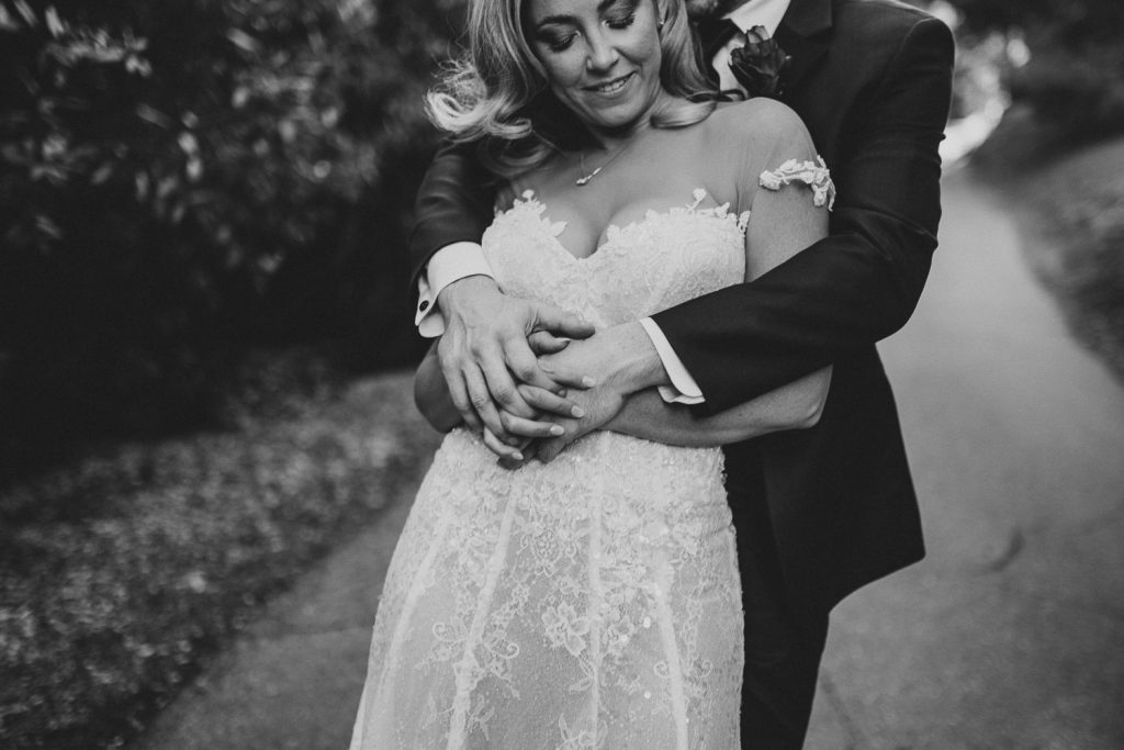 Bride and groom's black and white portrait in hills of los angeles