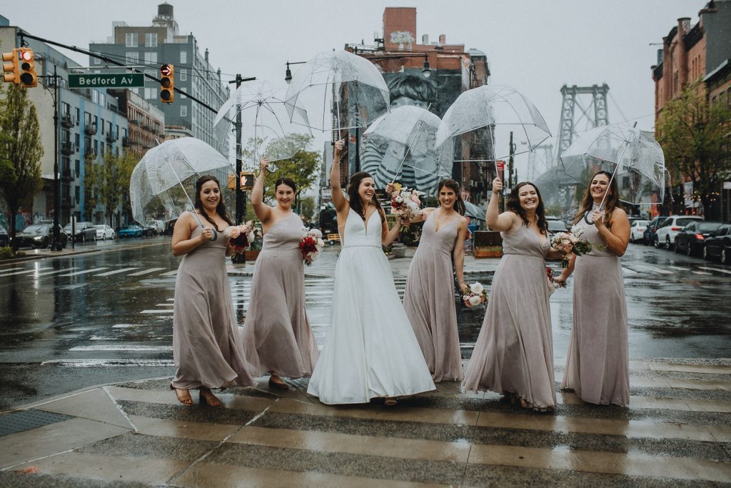 Bridesmaids holding umbrellas at rainy brooklyn wedding