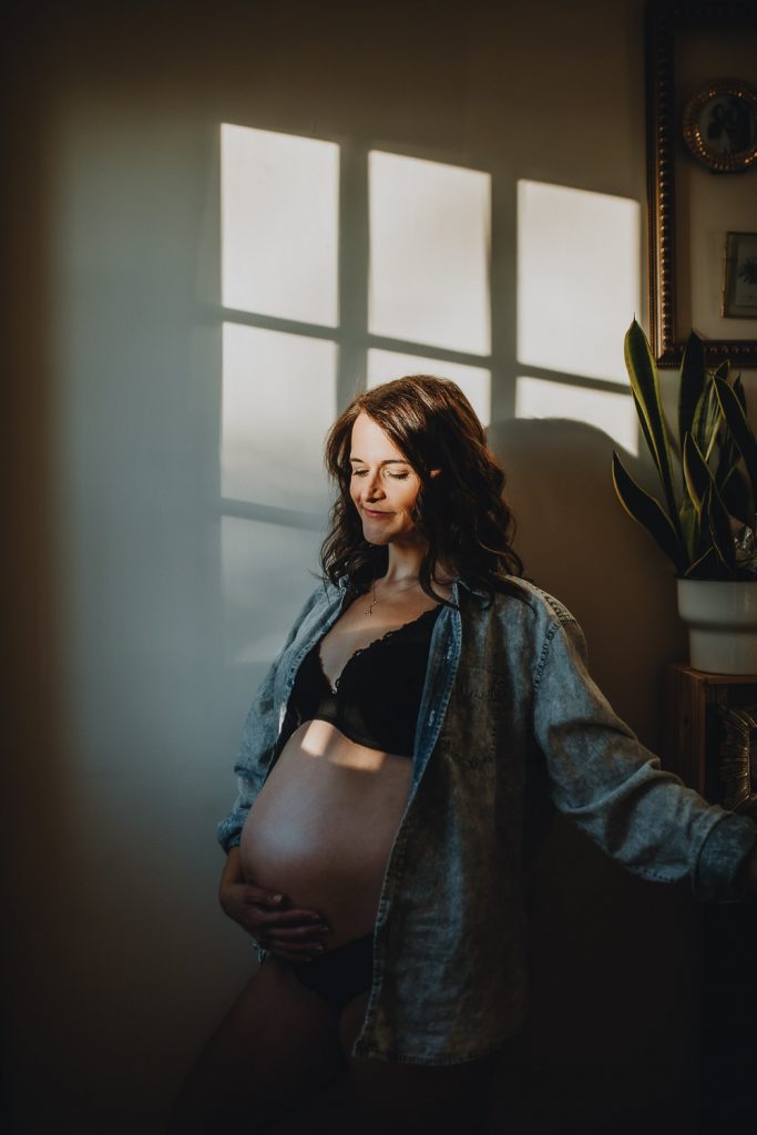 Pregnant woman during intimate maternity session in nyc home