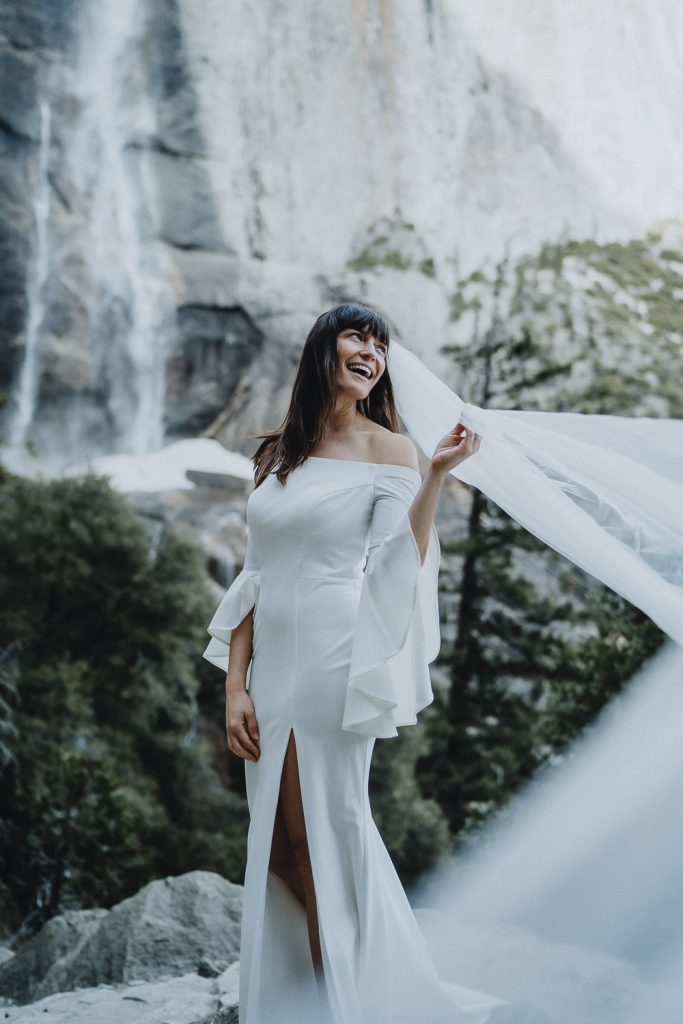 Bride with veil flying during yosemite elopement