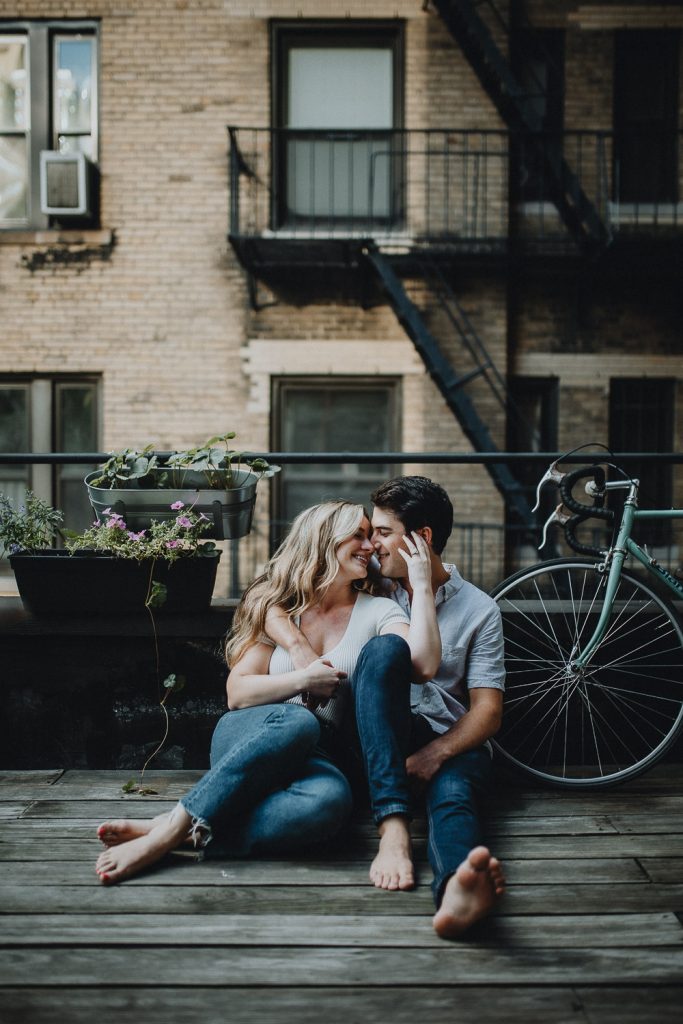 Couple during engagement session at home on brooklyn rooftop