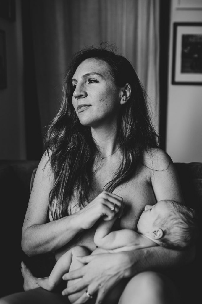 Mother breastfeeding newborn during in home session in brooklyn