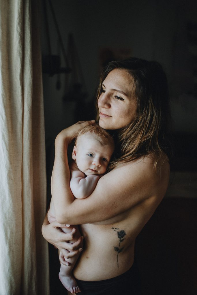 Mother doing skin to skin with newborn baby during in home session in brooklyn
