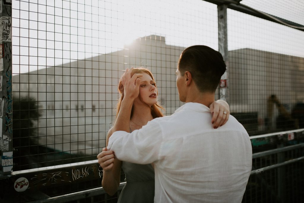 Couple during engagement photoshoot in bushwick brooklyn at golden hour