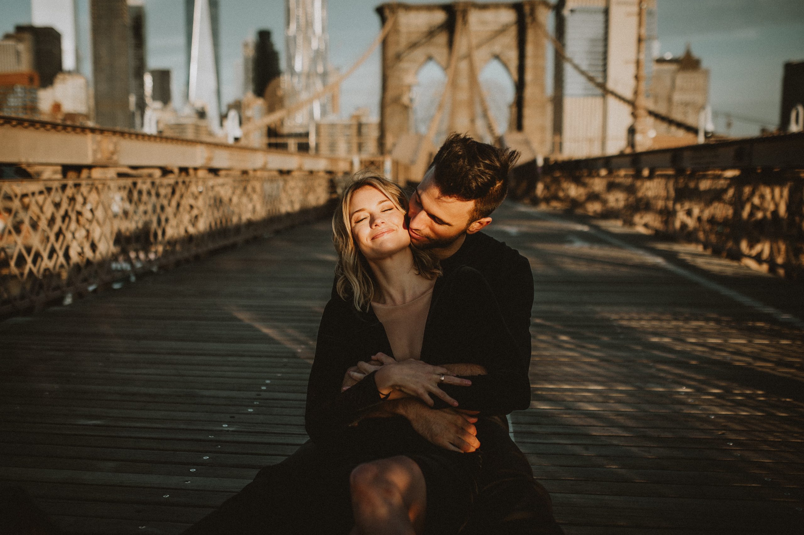 Couple on brooklyn bridge at sunrise during engagement shoot