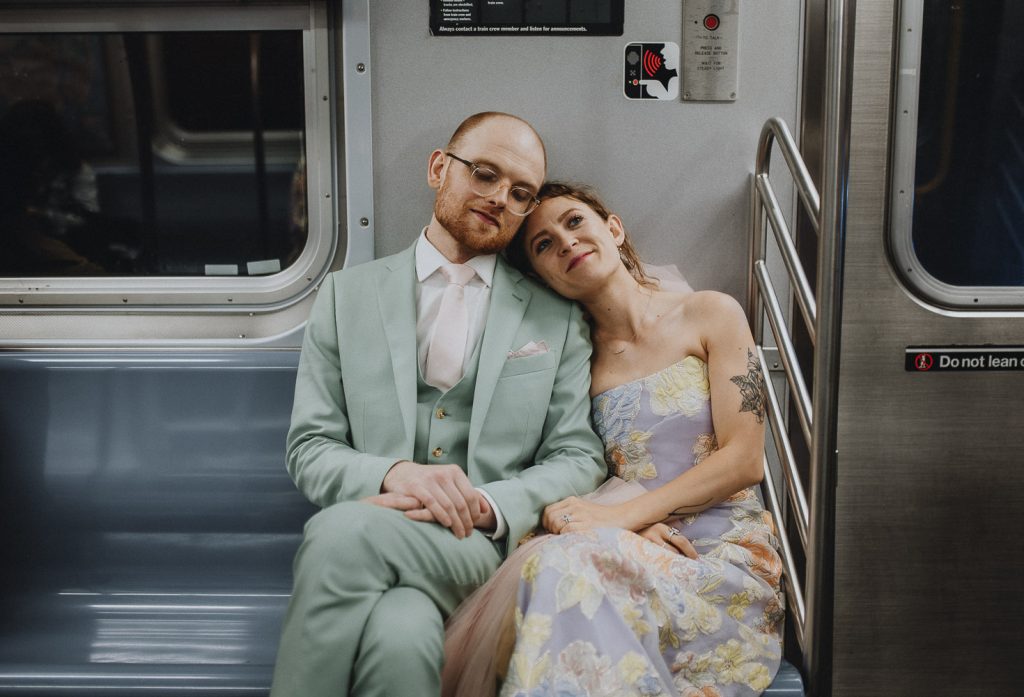 Bride and groom in nyc subway on wedding day
