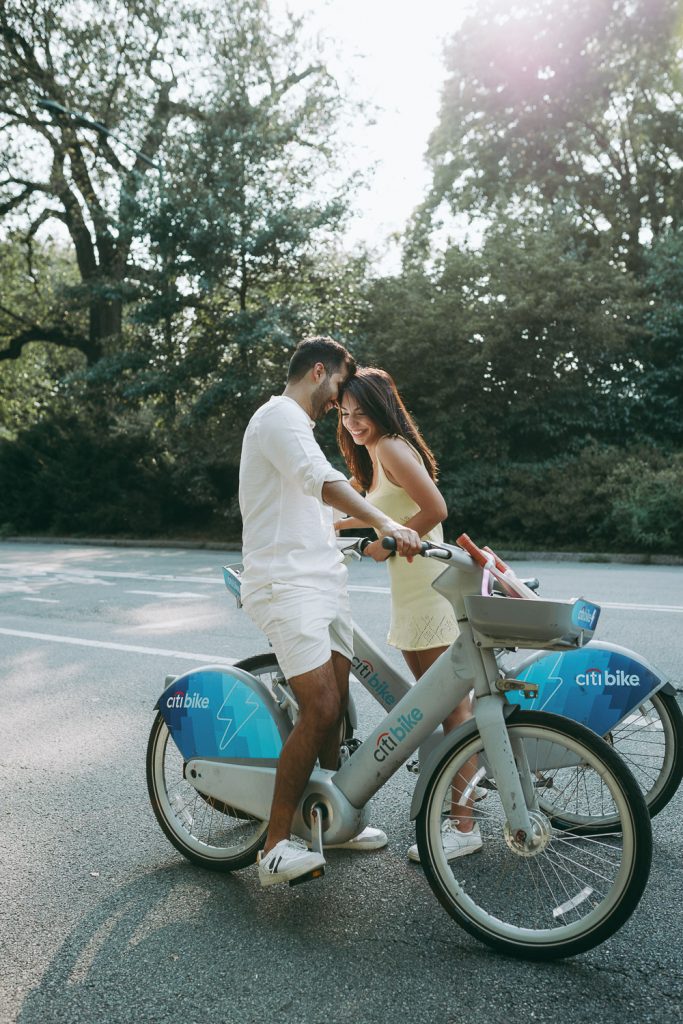 Couple riding bikes during engagement photoshoot in nyc