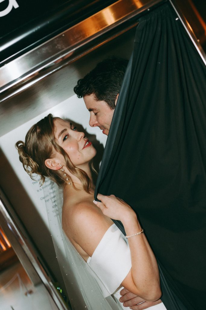 Bride and groom in hotel photo booth at nyc wedding