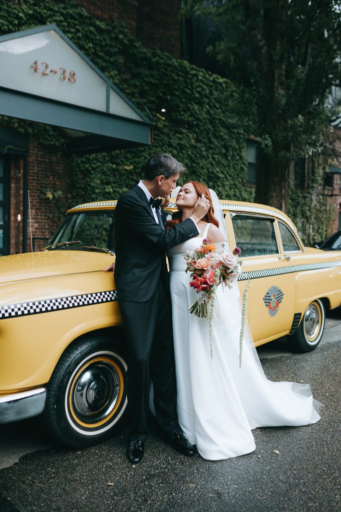Bride and groom in front of vintage nyc taxi cab at the foundry wedding