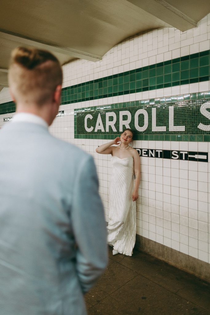Bride and groom in nyc subway on wedding day