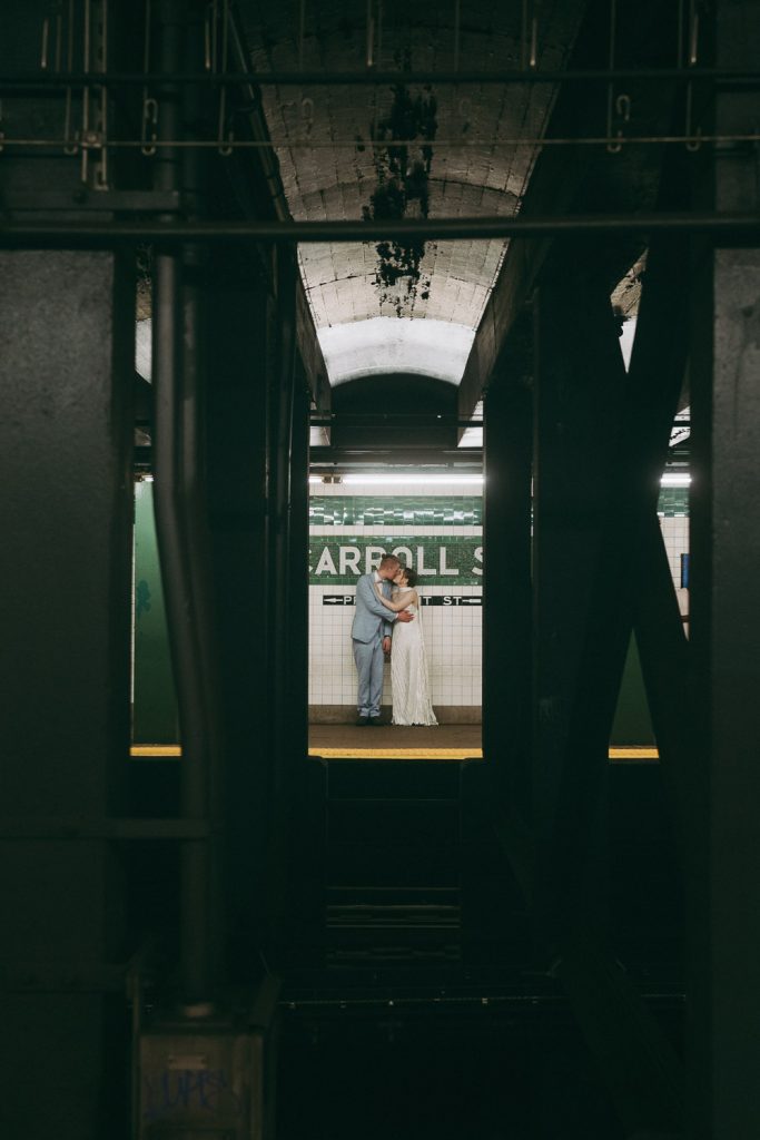 Bride and groom in nyc subway on wedding day