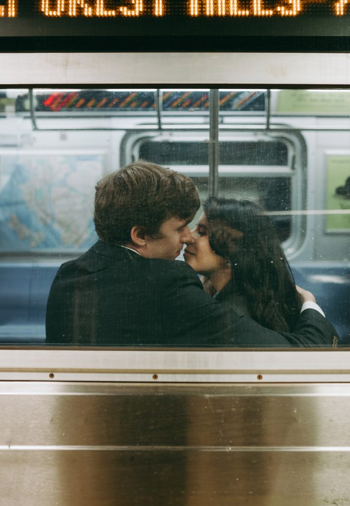 Bride and groom riding nyc subway on wedding day