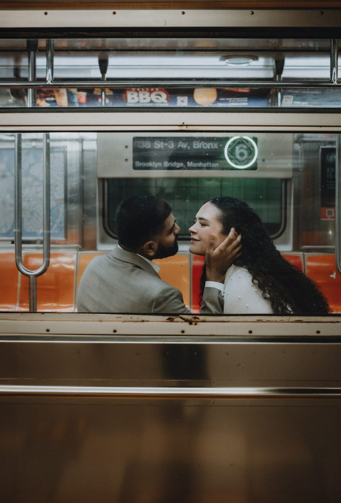 Bride and groom riding nyc subway on wedding day