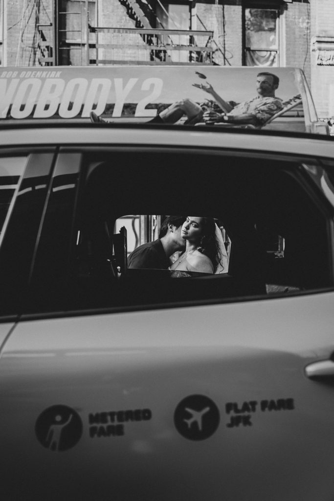 Bride and groom in nyc taxi during elopement wedding