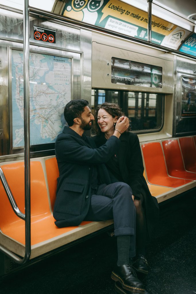 Couple taking engagement photos in nyc subway