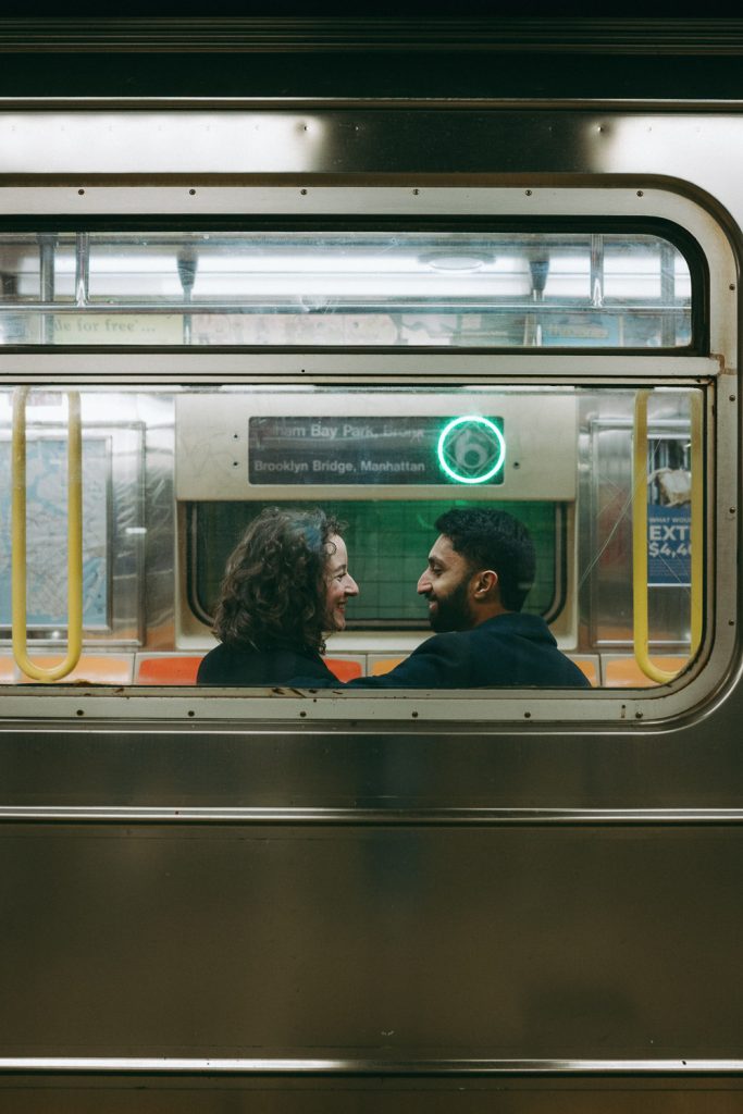 Couple taking engagement photos in nyc subway