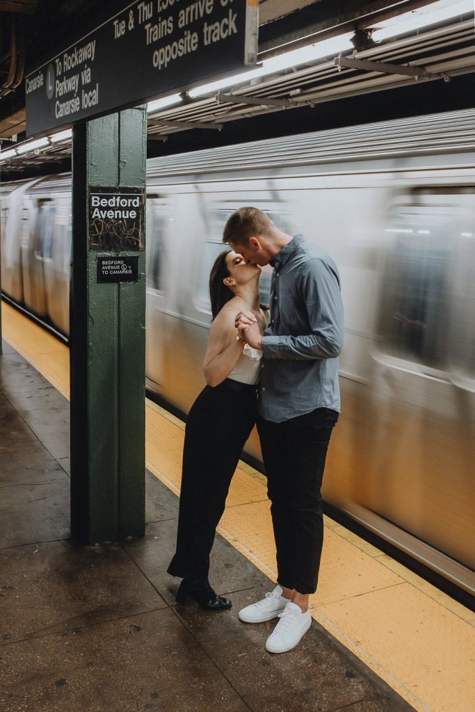 Couple taking engagement photos in nyc subway