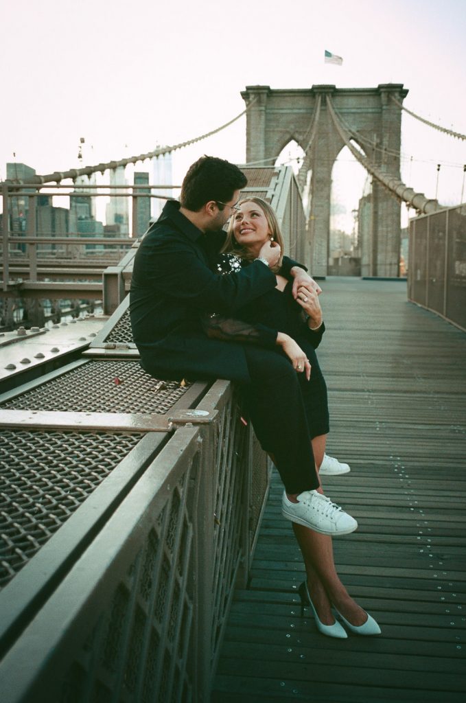 Couple during engagement photoshoot on brooklyn bridge (film photo)