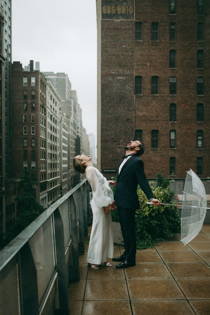 Bride and groom during rainy wedding on nyc rooftop
