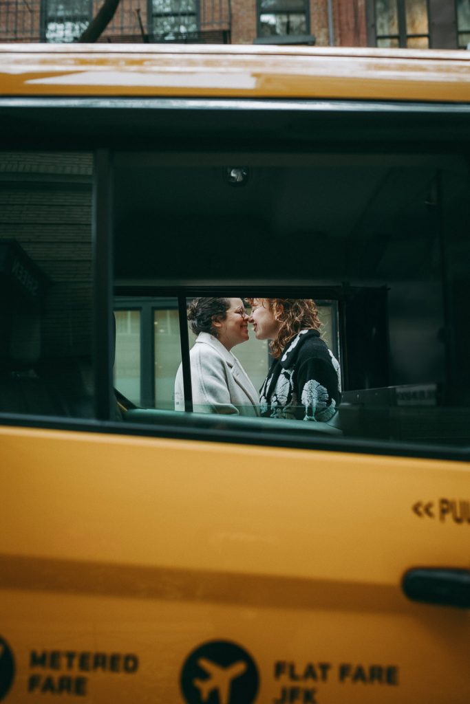 Gay couple at elopement wedding in nyc taxi