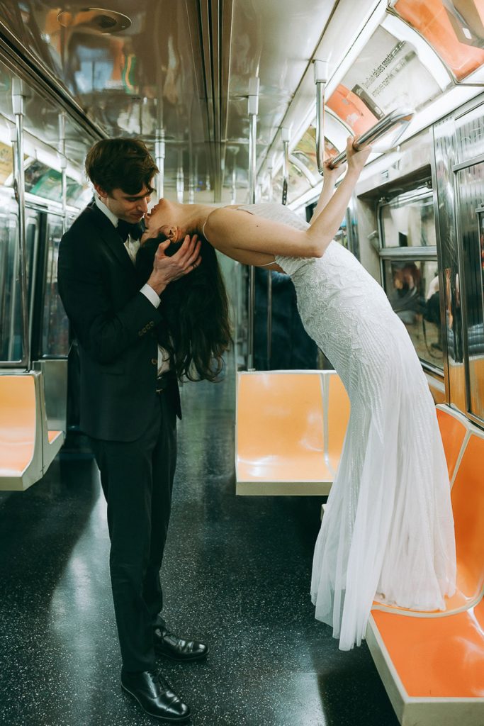Bride and groom riding nyc subway on wedding day