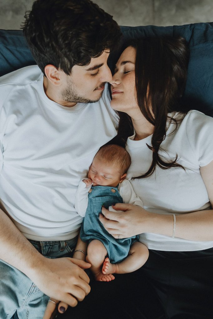 Parents with newborn during session at home in brooklyn