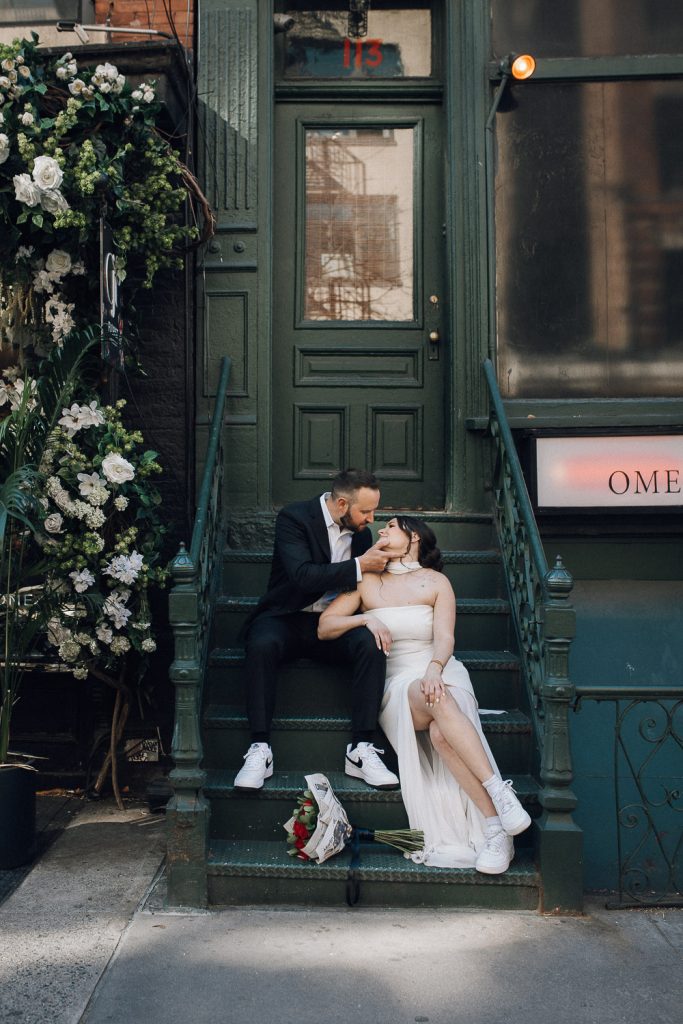 Bride and groom on brownstone stoop at nyc wedding