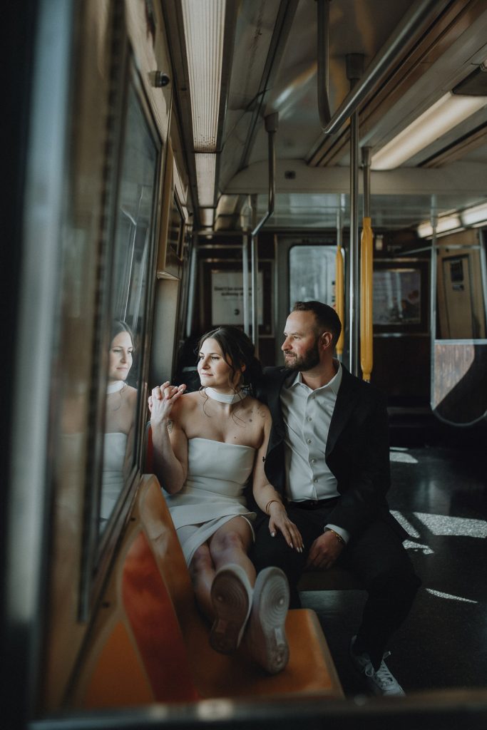 Bride and groom riding nyc subway on wedding day