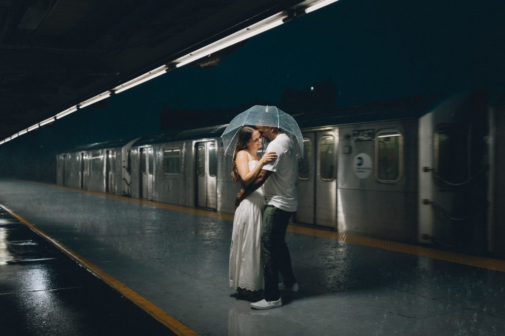 Rainy engagement session in nyc under clear umbrella